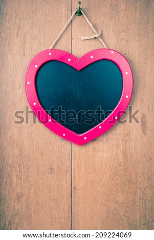 Valentine heart sign board on wooden vintage background
