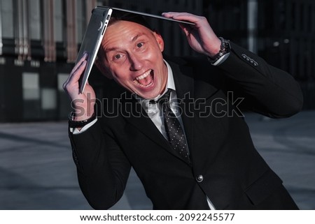 Stylish young businessman with laptop evening on sunset after work. Relaxed male business man banker in background office located in financial district. Copy space