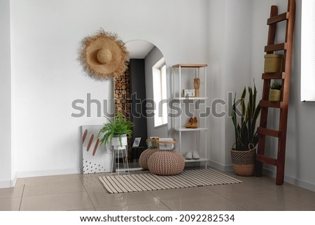 Mirror with stepladder and shelf unit in interior of light living room