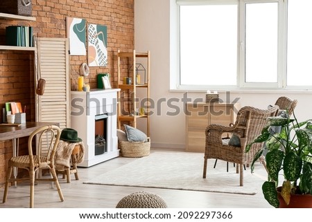 Interior of stylish room with fireplace and folding screen