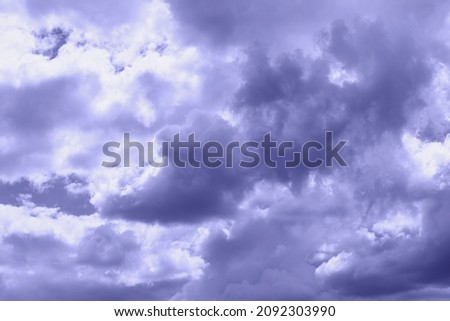 Trendy very peri color concept of the year 2022, violet blue, lavender dramatic sky with clouds. Overcast and cloudy