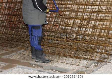 men cutting rebar on a construction site stock photo