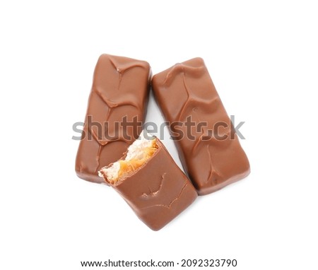 Chocolate bars with caramel, nuts and nougat isolated on white, top view Royalty-Free Stock Photo #2092323790