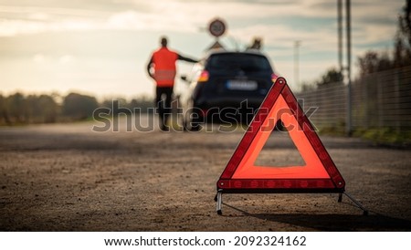 red warning triangle warn of car breakdown