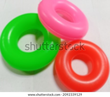 defocused abstrac background of colored donut shaped toy