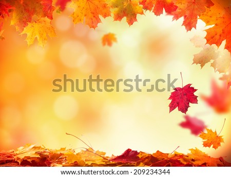 Moody autumn background with falling leaves on wooden planks