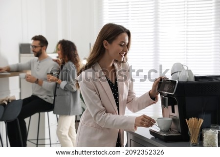 Woman preparing fresh aromatic coffee with modern machine in office Royalty-Free Stock Photo #2092352326