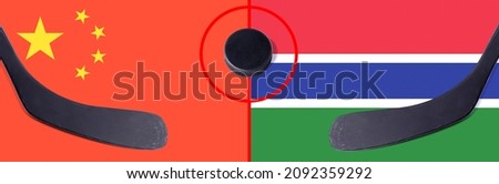 Top view hockey puck with China vs. Gambia command with the sticks on the flag. Concept hockey competitions