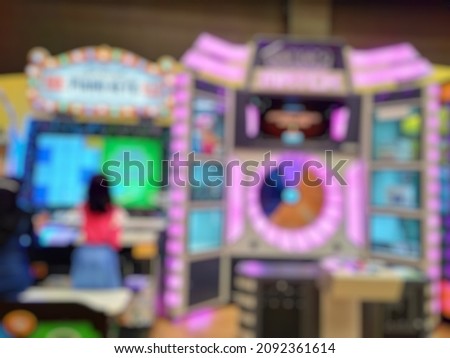 Bokeh image of Kid girl playing game inside indoor Game zone.