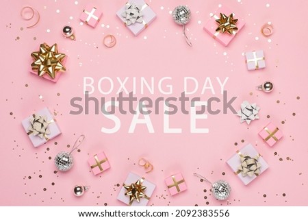 Boxing Day Sale promotion composition background. Christmas Shopping, Offer, Sale Concept. Holiday decorations and festive gift boxes on pastel pink background. Flat lay, top view, copy space. 