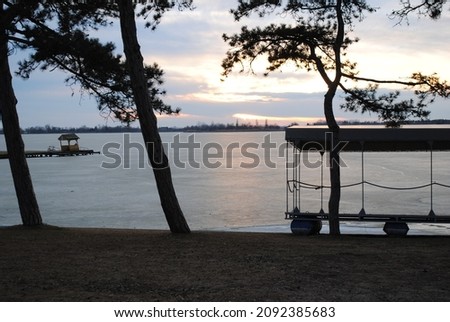 Frozen Lake with wooden dock in December 