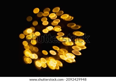 sparkling abstract bokeh background yellow color with glitter circles defocused golden particles on dark background for overlay screen. Abstract Festive vintage lights defocused.