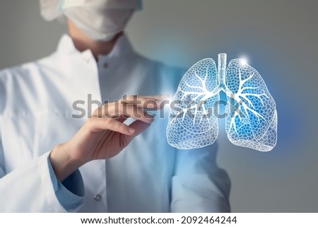 Female doctor touches virtual Lungs in hand. Blurred photo, handrawn human organ, highlighted blue as symbol of recovery. Healthcare hospital service concept stock photo Royalty-Free Stock Photo #2092464244