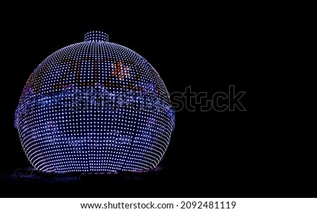 Large glowing LED ball with year 2022 numbers on dark black background