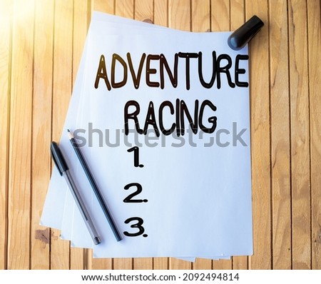 Handwriting text Adventure Racing. Conceptual photo disciplinary sport involving navigation over unknown course Office Stationery Paper Clipped Together Laying Flat On Table.