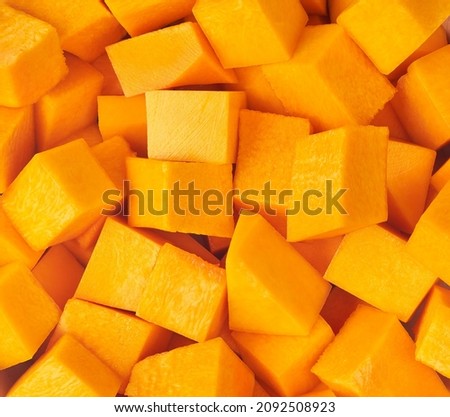 group of cut and slice butternut squash chunks on background. butternut squash chunks texture close up.