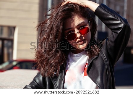 young pretty asian girl wearing sunglasses outside on big city street, lifestyle people concept