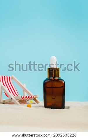 Summer sunscreen cream banner ads. Beach holiday cosmetics. Sun cream and sun essence. Unisex cosmetics. Concept photo of relaxing on the beach. Deck chairs on the sand on a blue background. Mockup 