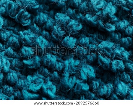 Background texture of blue pattern knitted fabric made of angora or wool. close up.