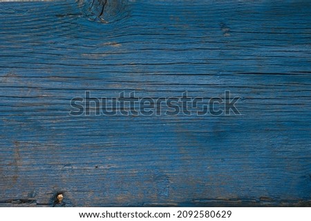 old wooden fence painted with blue paint. close-up. the photo shows the texture of the wood. can be used as a photo background