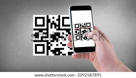 Cropped hand scanning qr code with smart phone with copy space on gray background. wireless technology, mobile app and cashless technology concept.