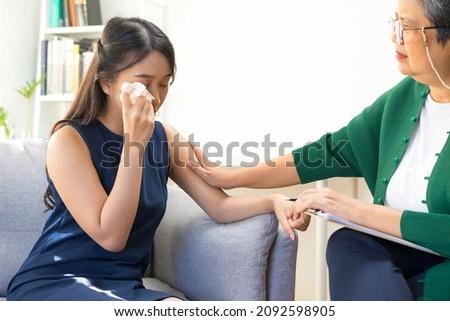 Young Asian woman with depression crying and having consultation session with psychiatrist in mental health service center. Royalty-Free Stock Photo #2092598905