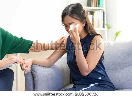 Young Asian woman with depression crying and having consultation session with psychiatrist in mental health service center. Royalty-Free Stock Photo #2092598926