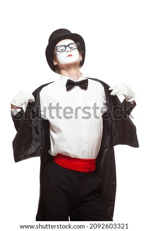 Portrait of a male mime artist performing, isolated on white background. He takes off his jacket. Symbol of seduction, charm, flirting Royalty-Free Stock Photo #2092603321