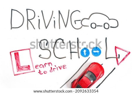 Driving school chalkboard, Educational and Creative composition with the Driving school caption. toy car model. traffic signs. White isolated background, board for markers