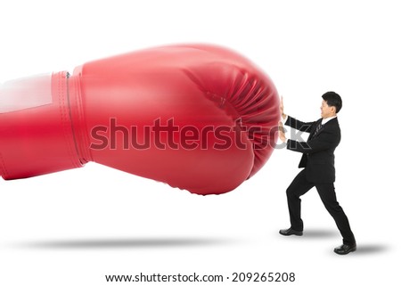 Businessman protect himself by push red glove punch him with white background