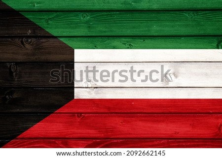 Flag of Kuwait on wooden surface