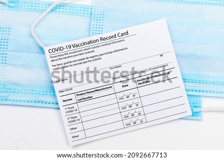 Coronavirus vaccination record card. Protective mask divided into two parts. Concept of defeating Covid-19