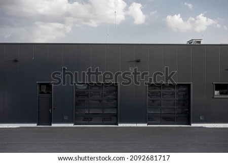 The car service building with two entrances to a garage Royalty-Free Stock Photo #2092681717