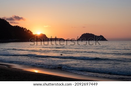 Ratón de Getaria famous landmark at sunset time by the sea, picture taken from Zarautz beach, Basque Country, Guipúzcoa, Spain