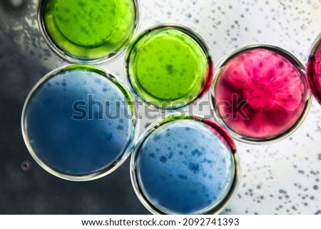 green, red and blue oil droplets in water macro