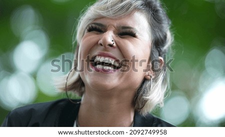 Young woman authentic laugh and smile outside