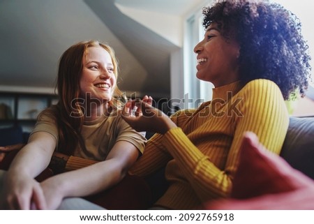 Multicultural gay women talking cheerful sitting on the couch - Couple of young lesbian girls having fun at home Royalty-Free Stock Photo #2092765918