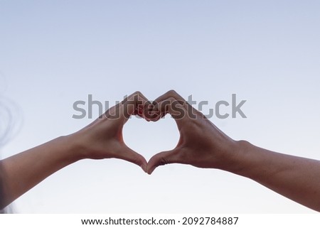 Valentine couples use their hands to make heart symbols to symbolize friendship and loving-kindness towards their lover and friends because heart symbols signify love, friendship and kindness.