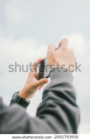 hand with smartphone photography ,Hands taking a picture of the coast with copy space