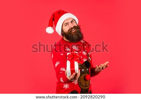 Ho Ho Ho. cheerful man with beard in santa claus hat. brutal man hold present box. bearded hipster in xmas sweater. christmas online shopping. winter holiday party. mature guy celebrate new year