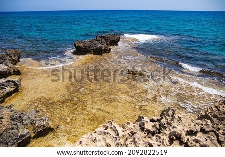 rocky sea shore against the background of waves
