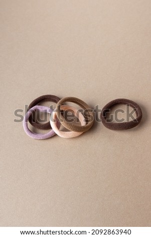 Set of different soft elastic bands for hair on beige background