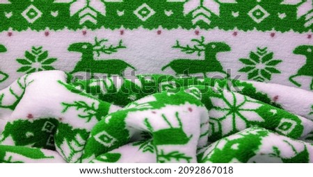 Velvet. Plush. For winter wear. Snow deer, snowflakes. Green and white tones. Silk fabric with soft, smooth and thick pile. Rich Silk Cloth
