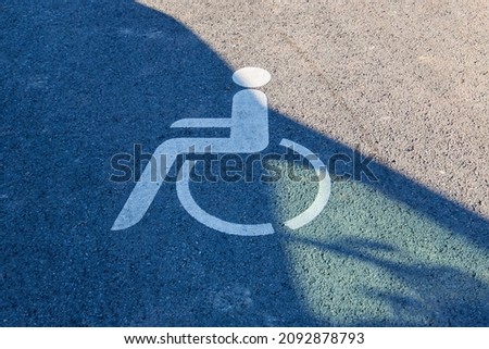 Pictogram painted on the road - indicates a parking space for the disabled.