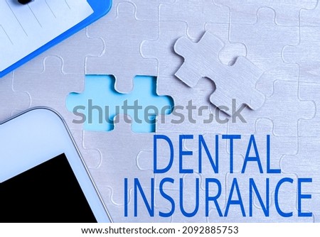 Conceptual caption Dental Insurance. Internet Concept form of health designed to pay portion or full of costs Building An Unfinished White Jigsaw Pattern Puzzle With Missing Last Piece