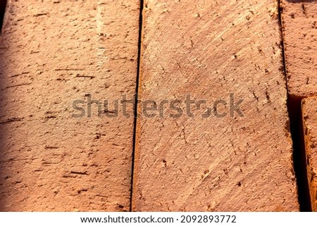 Red inexpensive brick. Topic - advertising backgrounds of building materials