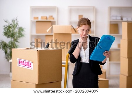 Young female professional mover doing home relocation