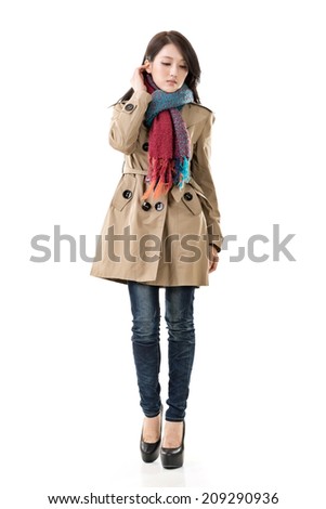 Attractive Asian lady with coat in winter, full length portrait isolated on white background.