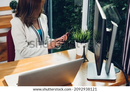 Business woman lifestyle using mobile smartphone working with laptop computer in desk office