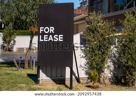 For lease sign on a blue display outside of a resedential building in Australia. Investment property real estate concept